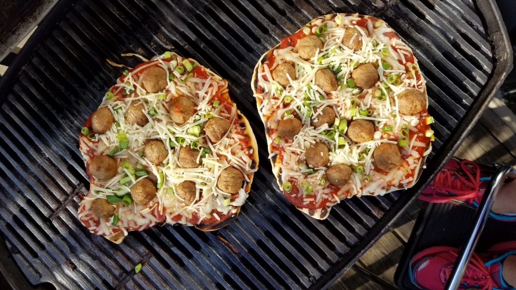 Kid-friendly meatball pizza on the grill for family dinners, picnics and cookouts.